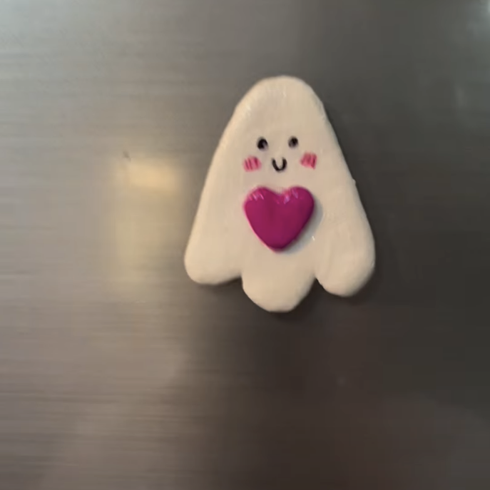 Cute white ghost fridge magnet holding a pink heart