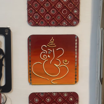 Lippan art wall panel of Ganpati Bappa in terracotta and gold with mirror work